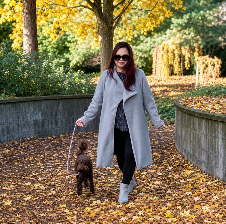 Aaronna Martin walking her dog Penny through autumn leaves